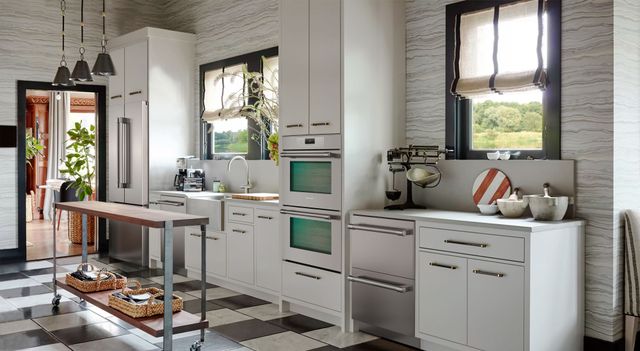 view of a modern kitchen with white cabinets and stainless steel Thermador appliances throughout