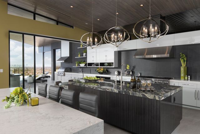 view of a large luxurious kitchen with thermador appliances including a range top