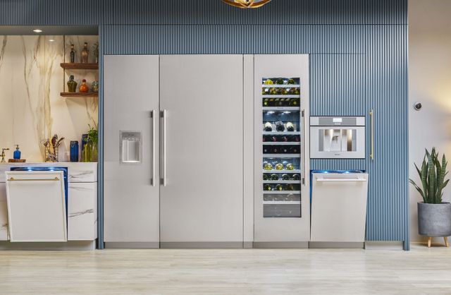Front view of a modern kitchen with a Thermador column refrigerator, freezer, and wine coolder