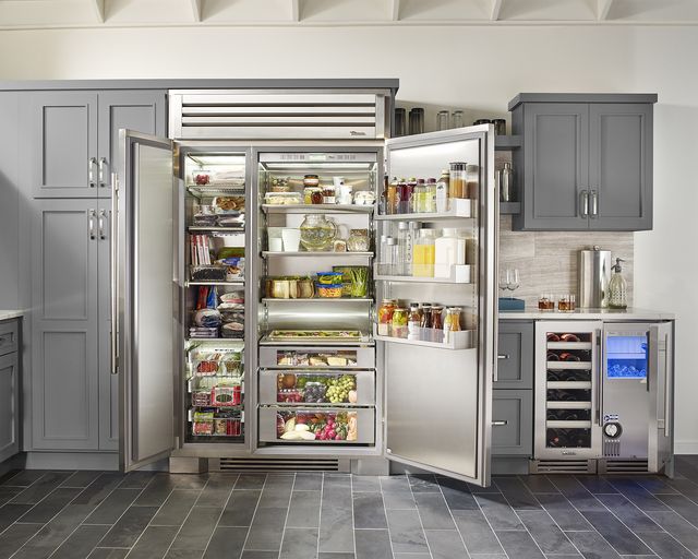 Front view of a modern kitchen with an open side by side True refrigerator