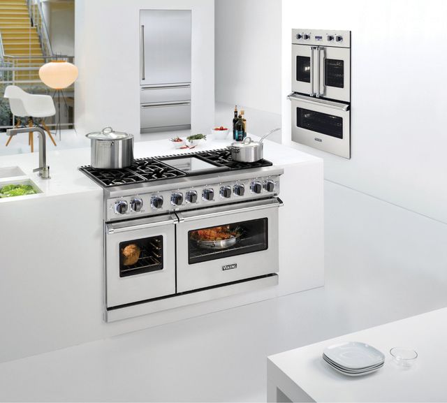 front view of a large modern white kitchen with a Viking Pro-Style range