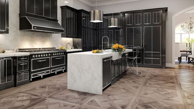 front view of a large luxury kitchen with black cabinetry and appliances including a large viking pro-style range