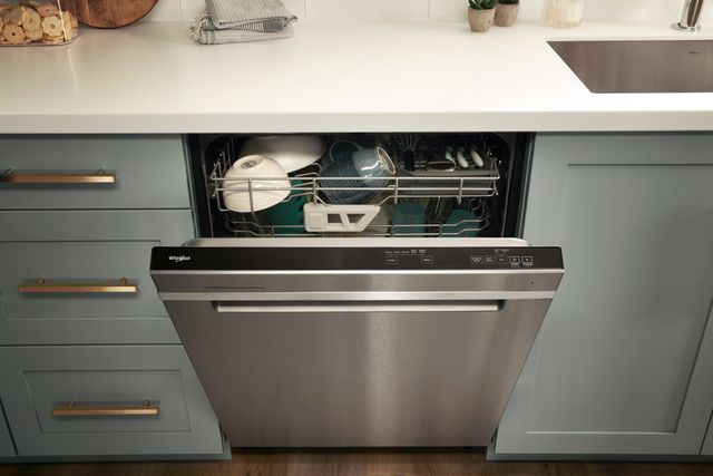 Front view of a slightly opened Whirlpool dishwasher in a modern kitchen