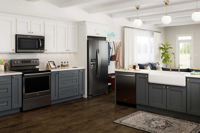 front view of a modern kitchen with Whirlpool appliances including a side-by-side refrigerator