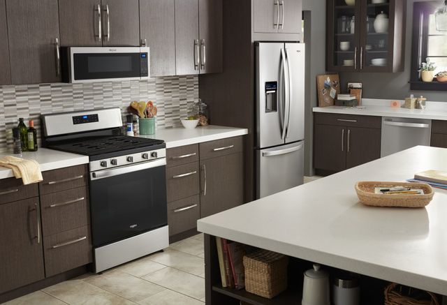 Front view of a modern kitchen with Whirlpool stainless steel appliances