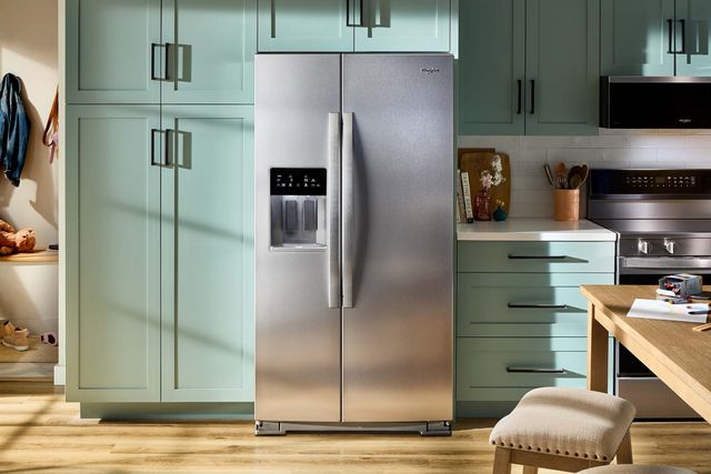 Front view of a modern kitchen with a Whirlpool side-by-side refrigerator