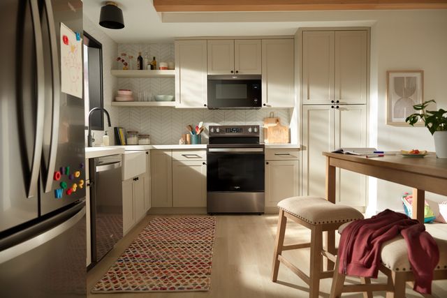 Front view of a modern kitchen with a Whirlpool kitchen appliance package