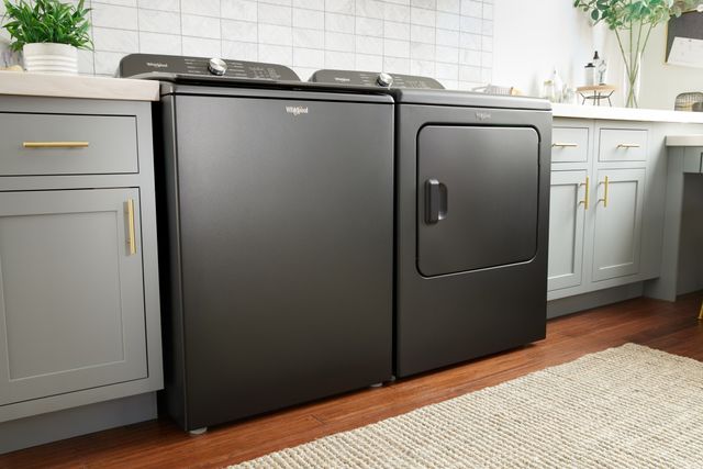 front view of a Whirlpool grey washer and dryer in a modern laundry room