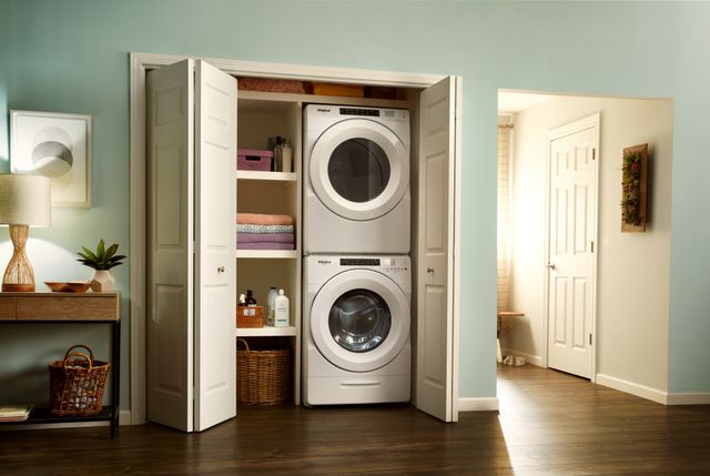Front view of a Whirlpool stackable washer and dryer pair in a white closet