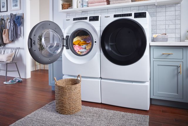 front view of a white whirlpool washer and dryer in a modern laundry room