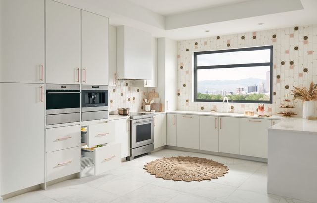front view of a wolf induction range in a modern kitchen with white cabients 