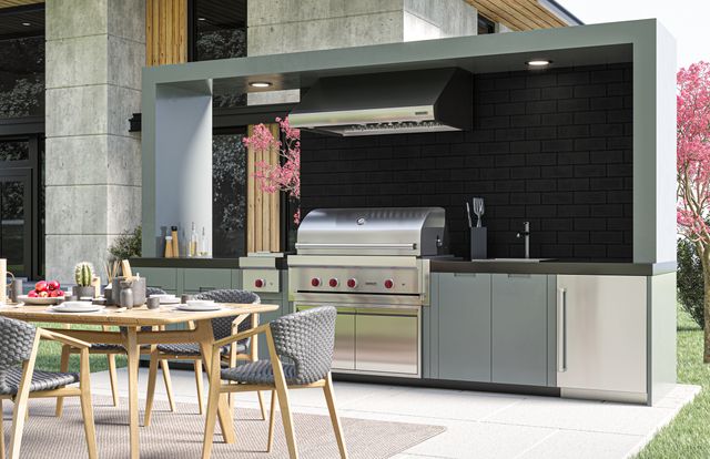 Front view of a modern outdoor kitchen with a Wolf grill.