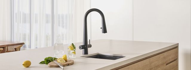 View of a modern bar with a small bar sink and luxury kitchen faucet