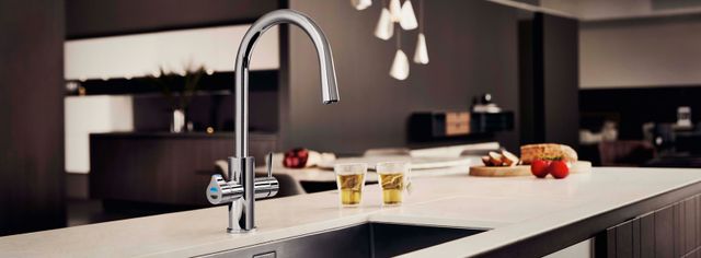 Front view of a luxury kitchen Zip water faucet in a contemporary space