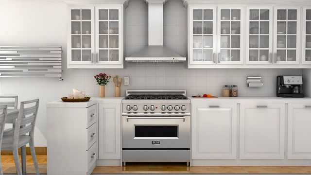 front view of a white kitchen with a stainless steel zline range and range hood 