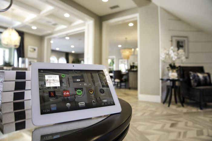 A smart home control device displayed in a home