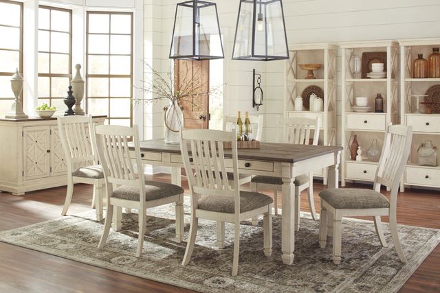 front view of a modern farmhouse dining room with an off white two tone dining table with matching chairs and a sideboard
