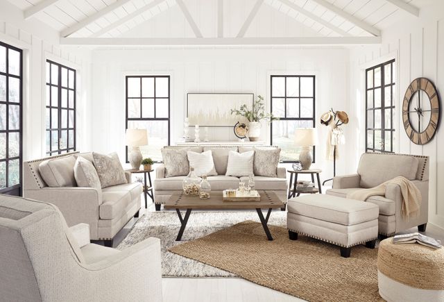 front view of a modern living room with bright white walls and a signature design by Ashley furniture set