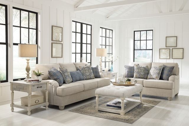Front view of a modern coastal living room with White walls, woven textures, and coastal furniture.
