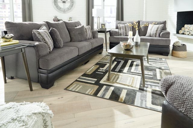 front view of a modern living room with signature design by ashley living room tables and furniture sets