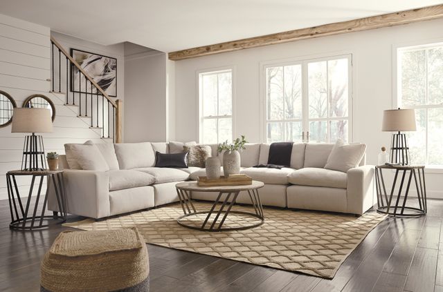 Front view of a farmhouse living room with a three piece table set around an L-shaped sectional