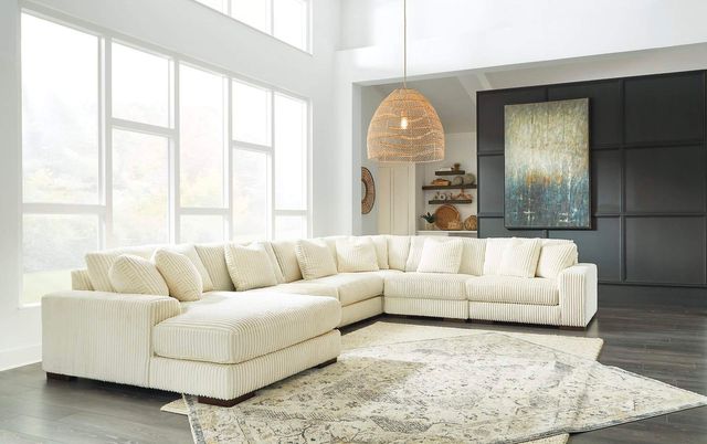 front view of a white plush signature deisgn by ashley large sectional sofa in a casual living room
