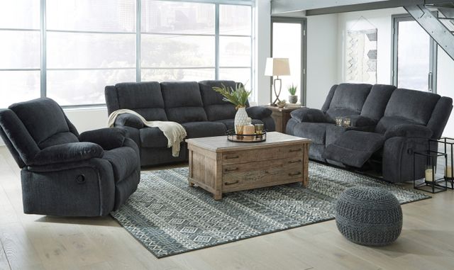 Front view of a modern living room with a three piece living room set with a loveseat, sofa and recliner