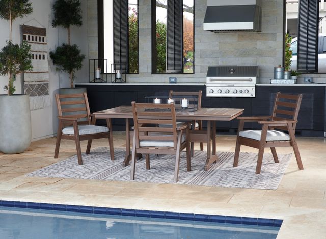 Front view of a modern outdoor kitchen and dining area with a grill and plastic table, all poolside