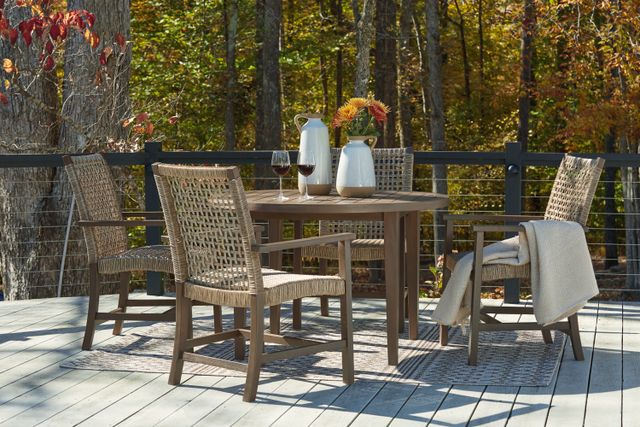 View of an engineered wood table and chairs on a modern outdoor balcony