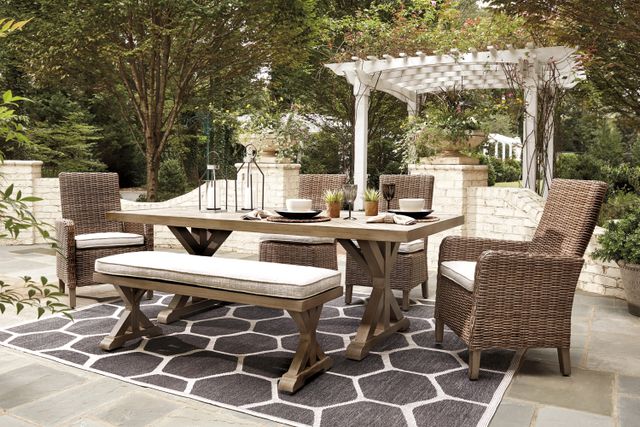 Front view of a casual outdoor space with a dining table and pergola