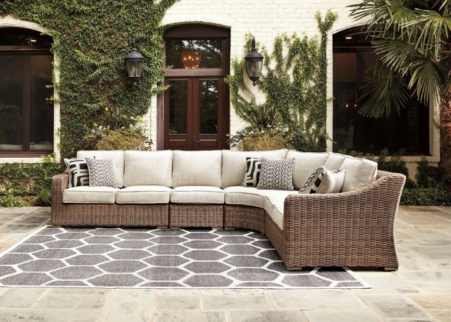 Front view of a modern backyard patio with an Ashley furniture outdoor sectional
