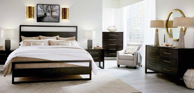 front view of a modern bedroom with white walls and a modern black bedroom furniture set including a bed, nightstand, dresser, and chest