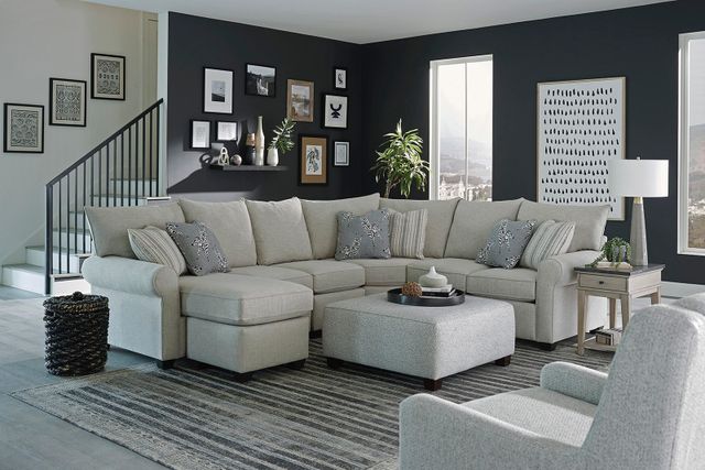 front view of a transitional black and white living room with a beige england furniture sectional