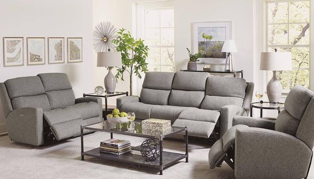 front view of a modern living room with a grey reclining sofa, loveseat, and chair from Flexsteel