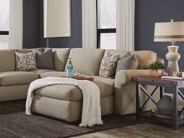 front view of a felxsteel chaise sectional with sparkling water on top