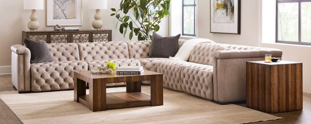 Opulent, tufted off white leather sectional sofa centered in a contemporary style living room