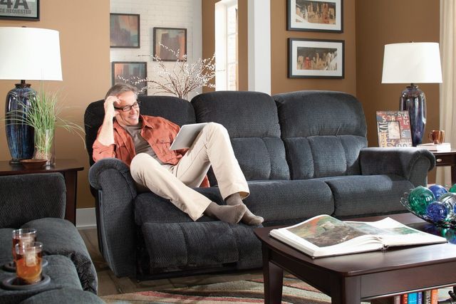 front view of a man relaxing on a flexsteel sofa in a casual space