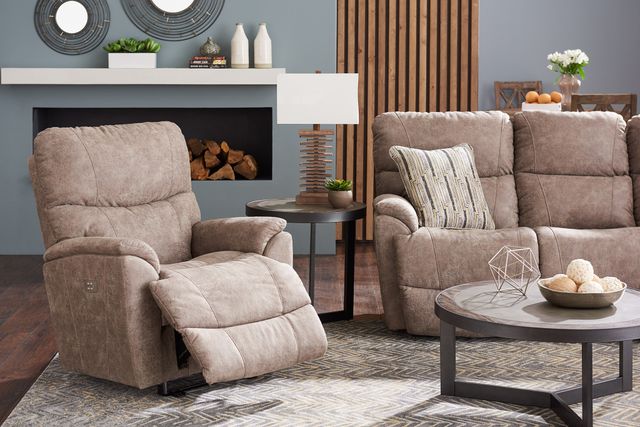 front view of a modern living room with blue walls and beige furniture, and a beige recliner partially reclined