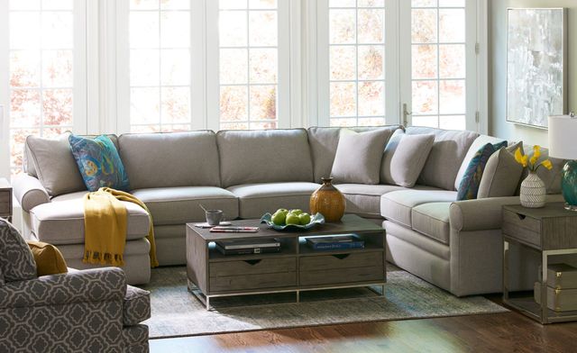 front view of a bright modern living room with a light beige lazy boy sectional