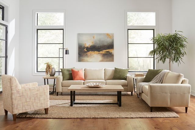 front view of a modern living room with a palliser sofa, loveseat, and accent chair showcasing various materials throughout the room