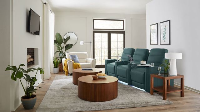 front view of a modern living room with white walls and a blue sectional sofa