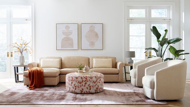 Front view of a modern bright living room with Palliser furniture including a sofa and two chairs