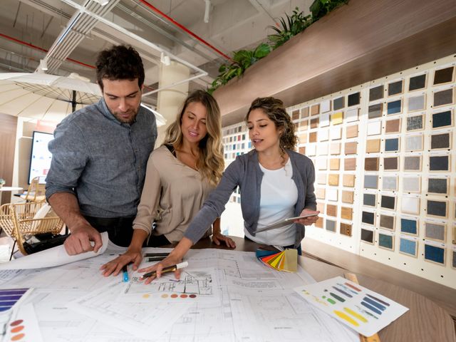 Front view of a couple in a store chatting with a designer
