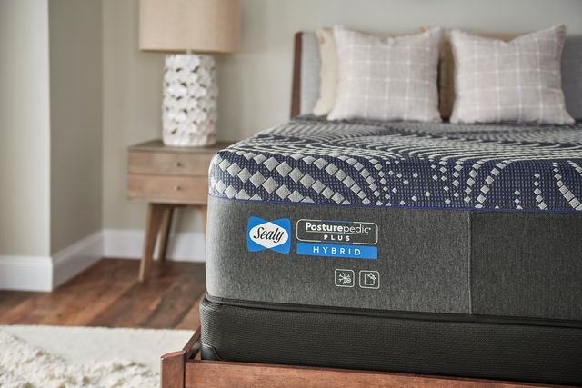 Close view of a Sealy Posturpedic queen mattress corner in a modern bedroom 