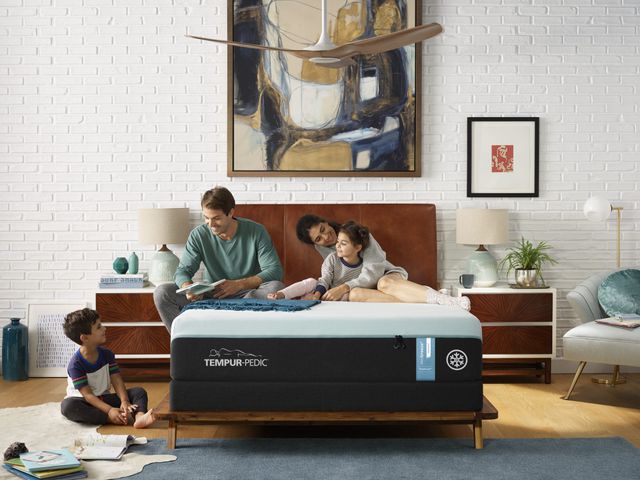 Front view of a family spending time on a Tempur-Pedic memory foam mattress