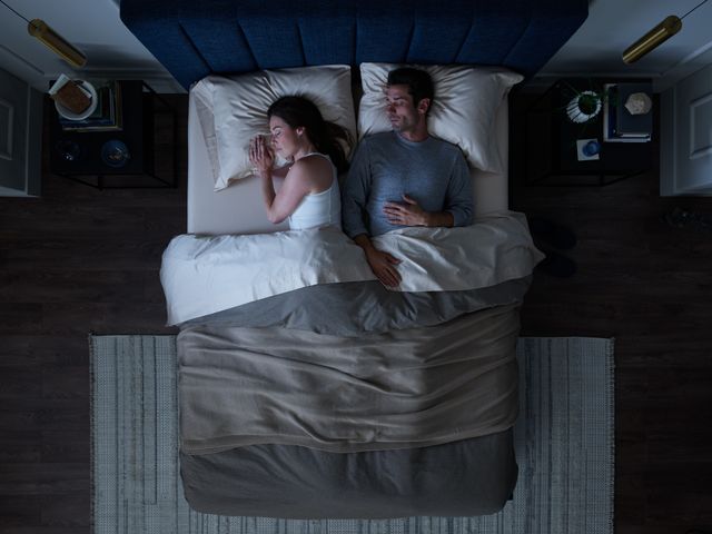 Top view of a man and woman sleeping together on ahybrid mattress