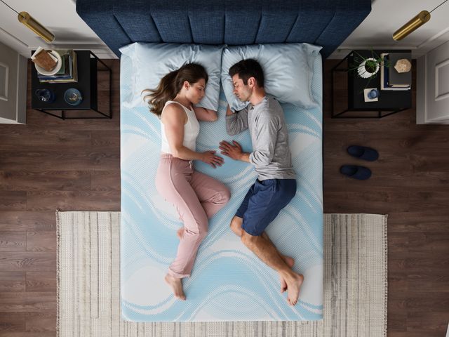 Front view of a man and woman sleeping on a Tempur Pedic memory foam mattress