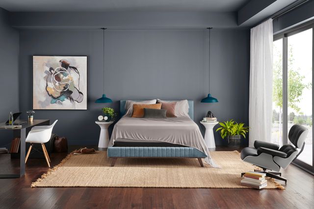 Front view of a modern bedroom with a bed frame, foundation, and Tempur-Pedic mattress with bamboo sheets.