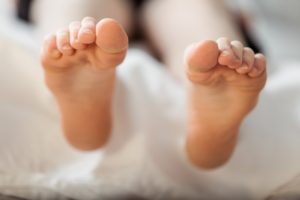 feet-outside-bed
