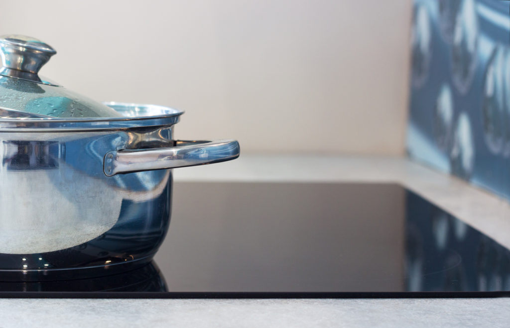 Big pot in modern kitchen with induction stove